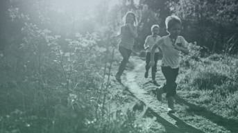 Kids running in the woods